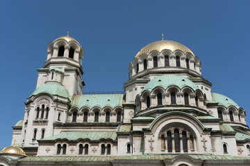 Fototapeta na wymiar church of st nicholas in town with huge facade and copper green dome
