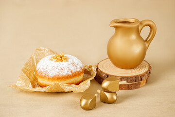 Jewish religious holiday Hanukkah with  donut, wooden dreidel (spinning top), oil jug, candles. Golden baner