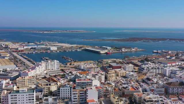 Aerial drone footage of the Portuguese southern town of Olhao. View of the industrial dock for fishermen.