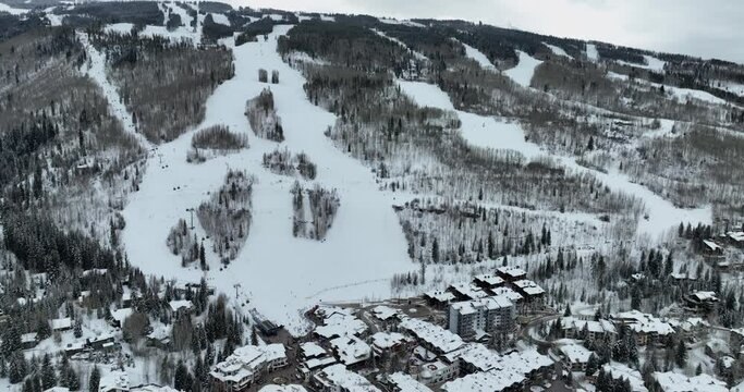 Aerial panorama of Vail, famous Colorado ski resort town in winter, buildings and slopes covered in snow