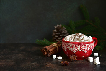 Christmas hot chocolate with marshmallow in a red cup.