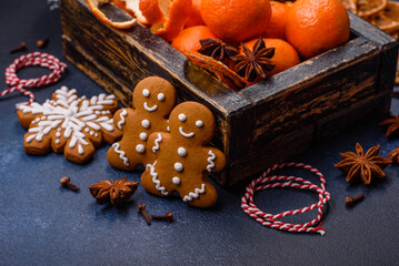 Beautiful festive Christmas composition of tangerines, gingerbread and star anise