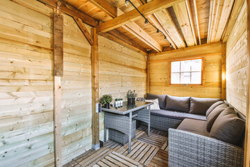 Wooden cabin with gray couch and coffee table