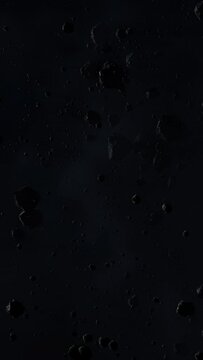 Asteroid belt field in dark outer space. 3D animation wide pan shot. Rock formations of cosmic debris and giant Meteorites. Celestial objects on starry stars background with dust nebula haze low light