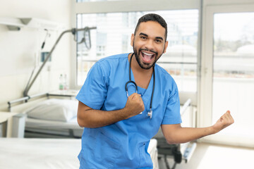 Motivated hispanic male nurse or doctor with beard and stethoscope at hospital room