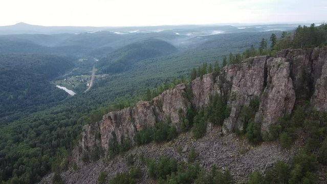 Aerial view of misty forest through cliffs
