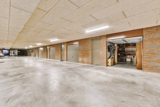 Fototapeta Empty corridor with storage rooms in industrial building