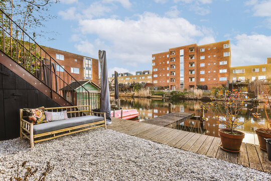 Deck with couch overlooking river and buildings