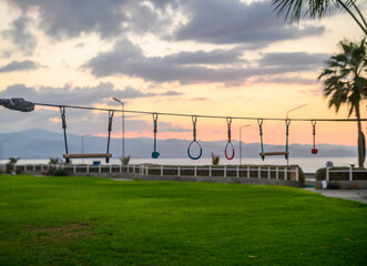 children's entertainment - rings, swings, stairs against the backdrop of sunset 2