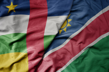 big waving national colorful flag of namibia and national flag of central african republic .