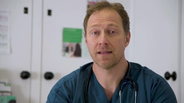 Male local doctor discusses patient symptoms over facetime.  Looking straight into camera, mid shot this is shot form the patients point of view