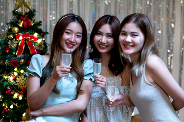 Group of female friends gathered to eat at a party with candles