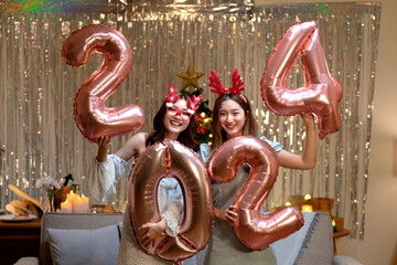 group of 3 friends holding the letters 2 0 2 4 to symbolize the new year 2024