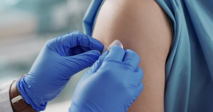 Doctor, plaster and hands on patient arm for vaccine and healthcare and wellness by injection. Nurse, bandage and closeup of illness prevention, virus protection and immunization or medicine to help