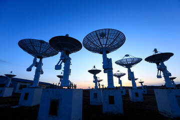 The silhouette of a radio telescope