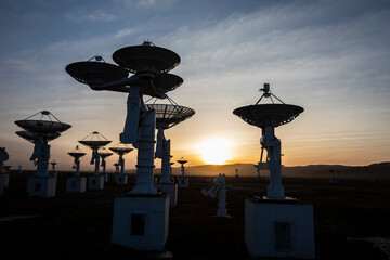 The silhouette of a radio telescope