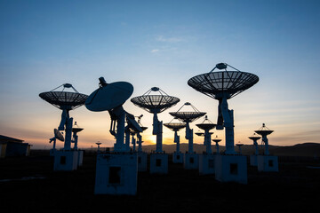 The silhouette of a radio telescope