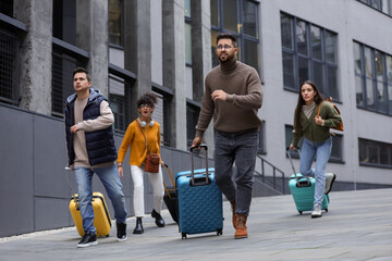 Being late. Group of people with suitcases running outdoors