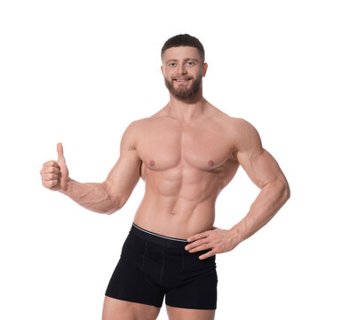 Young man is stylish black underwear showing thumb up on white background