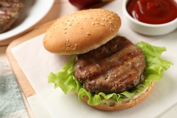 Delicious fried patty, lettuce, buns and sauce on table, closeup. Making hamburger
