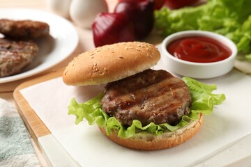 Delicious fried patty, lettuce, buns and sauce on table. Making hamburger