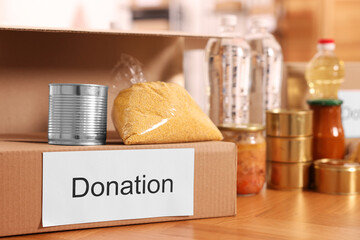 Volunteering. Different food products and cardboard boxes on table