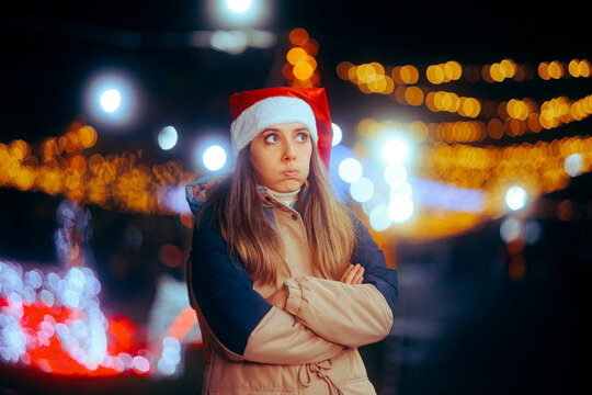 Stressed Christmas Woman Standing with her Arms Crossed Outdoors. Pensive girl feeling annoyed with all the plans and preparations for Xmas
