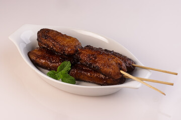 Banana Cue or Banana Q is a Popular Street Food from Philippine, Skewered Fried Plantains (Saba) Banana and Coated with Brown Sugar