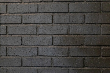 Black painted brick wall background texture with copy space