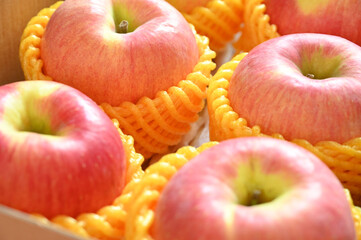 beautiful pink apple in yellow wrap bubble, healthy fruit in the box