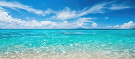 picturesque landscape of a white sandy beach, people bask summer sun, surrounded by the beauty of nature the azure sea, clear sky, and fluffy white clouds background.