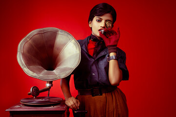 portrait of a woman with a gramophone and cigarettes in red background 