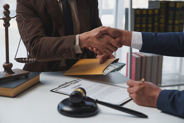 Lawyers shake hands with business people to seal a deal with partner lawyers or a lawyer discussing...