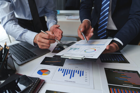 Asian male financial officer or accountant checking investment results Financial budget analysis Planning to summarize results and report to the meeting Audit concept and investment results.
