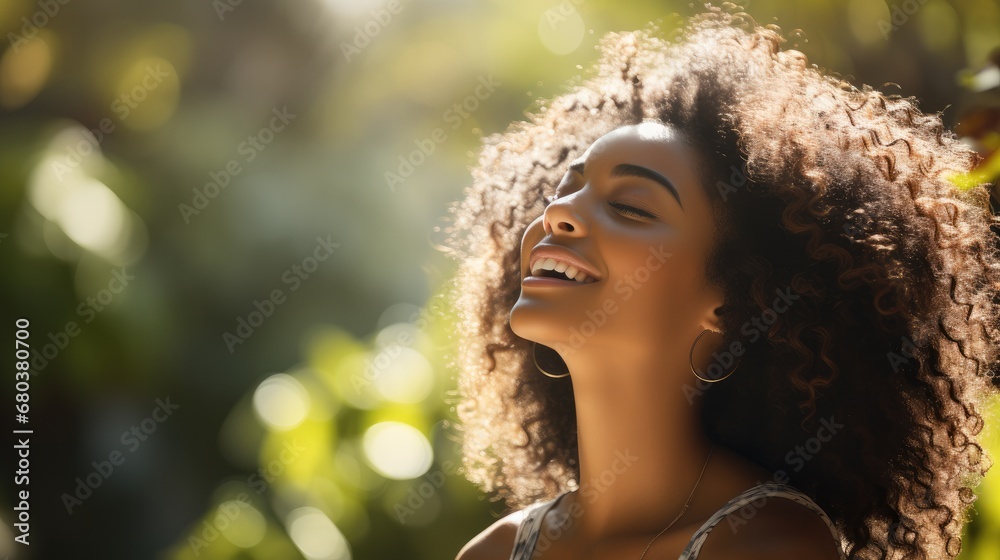 Poster Beautiful American African woman taking a deep breath in blurred garden background with sunlight.