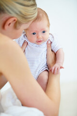 Care, family and mother with baby, love and cheerful with trust, playful and happiness with newborn. Mama holding child, kid and mom with nursery in a home, relax and bonding together with wellness