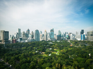 Aerial view of Lumphini Park backgrounded by the Silom area skyline office building business district