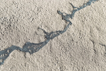 Abstract relief rough gritty neutral beige surface of background texture. Aesthetic pattern on sandstone. Top view textured sand, natural ornament or wallpaper, macro photo shore salt lake