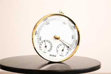Aneroid barometer on black table, closeup