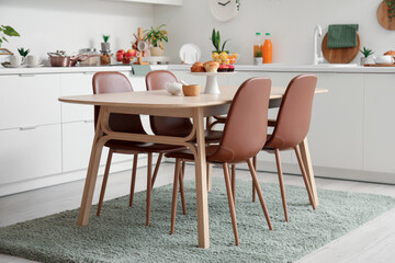 Interior of modern kitchen with wooden dining table