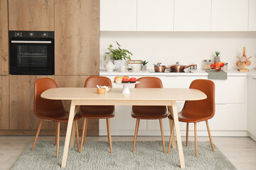 Interior of modern kitchen with wooden dining table