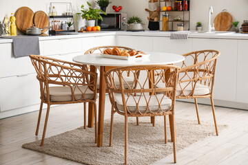 Interior of modern kitchen with wooden dining table