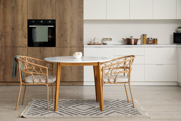 Interior of modern kitchen with sweets on dining table
