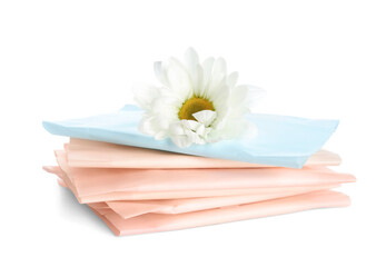 Stack of menstrual pads and chamomile flower on white background