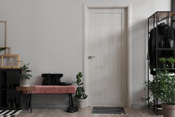 Interior of modern hallway with pink bench and houseplants