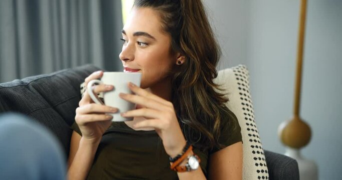 Woman, sofa and thinking with coffee, home and relax with happy memory, vision and peace in living room. Girl, tea cup and smile on lounge couch with ideas, remember or choice with drink in apartment