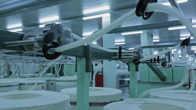 Factory for the production of cotton yarn, spinning machines. Textile factory, industrial textile production.