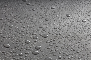 water droplets of various sizes are arranged randomly on a black background