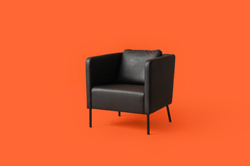 Modern black leather armchair on orange background