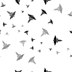 Seamless vector pattern with caduceus symbols, creating a creative monochrome background with rotated elements. Vector illustration on white background